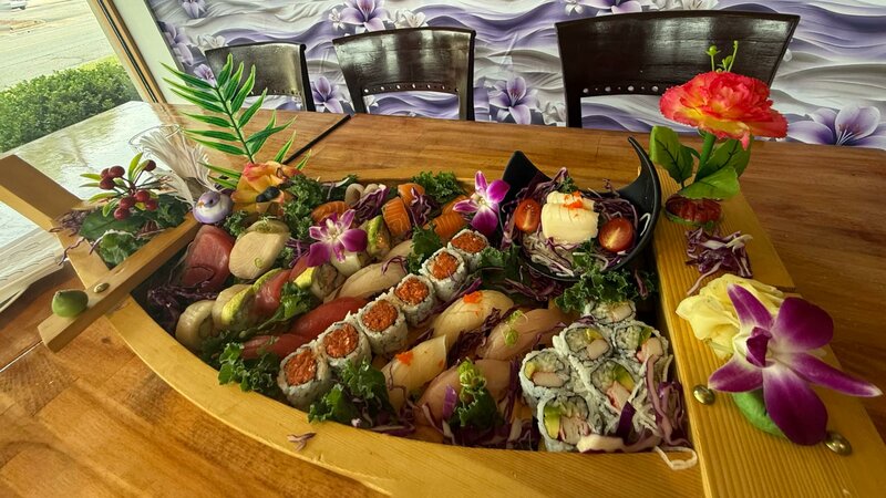 Wooden boat filled with sushi and sashimi